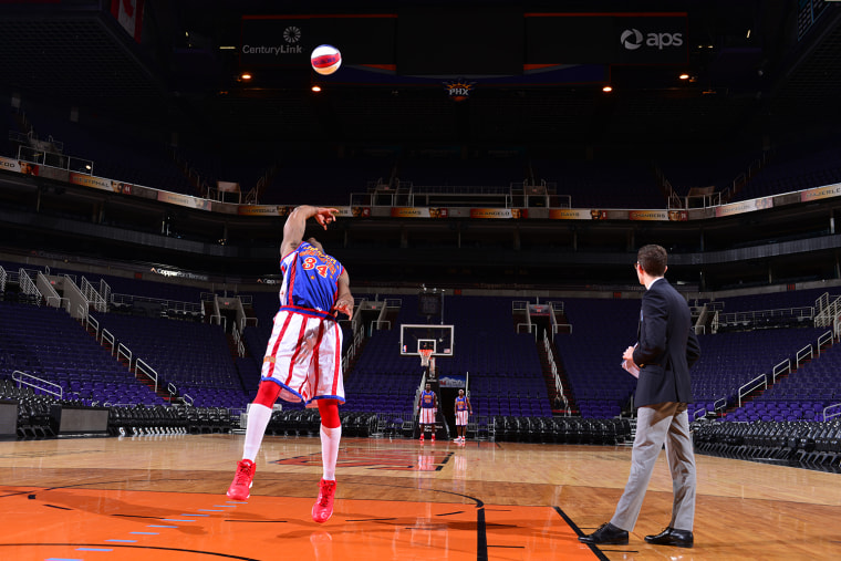 The farthest basketball shot made backwards was 25 m (82 ft 2 in) by Thunder Law of the Harlem Globetrotters (USA) at the US Airways Center in Phoenix, Arizona, USA in honour of Guinness World Records Day 2014. 

Online Press Office URL: http://onlinepressoffice.tnrcommunications.co.uk/ tallest-and-shortest-man  
Password:  records                
Site live from:  1700 GMT, Wednesday 12th November 2014
Media Materials available: 0800 GMT, Thursday 13th November 2014
You will be required to enter your name, the name of your organisation, a valid email address and the above password to gain access to the site. Please note that the password is case sensitive.  
All visitors must accept the Terms &amp; Conditions of use governing the site before entering.
Any problems, please contact TNR on  (0)20 7963 7163
